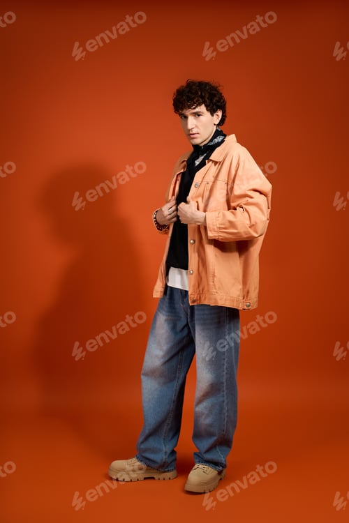 Preview: Captivating man exuding charm in stylish attire against a vibrant backdrop