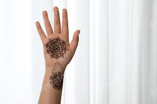 Preview: Little girl with henna tattoo on palm, closeup and space for text. Traditional mehndi ornament