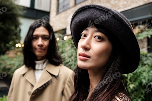 Preview: Fashionable asian couple posing together outdoors