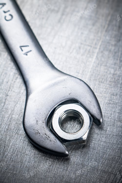 Preview: Metal wrench on the table.