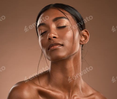 Preview: Its me that you adore. Shot of a beautiful young woman posing against a brown background.