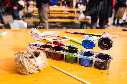 Preview: Craft materials such as paints and strings, used on a table.