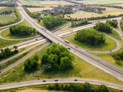 Preview: Top view of cars driving on round intersection in city. Aerial view of road in Germany