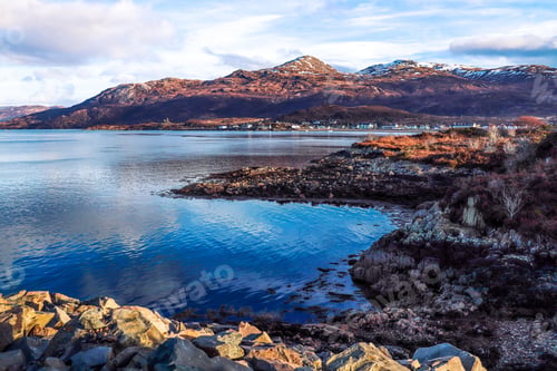 Preview: Beautiful shot of rocky cliffs and houses on the shore in Kyle of Lochalsh, Scotland, UK