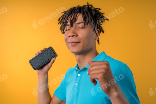 Preview: African american man dancing, enjoying on yellow studio background. Guy moves