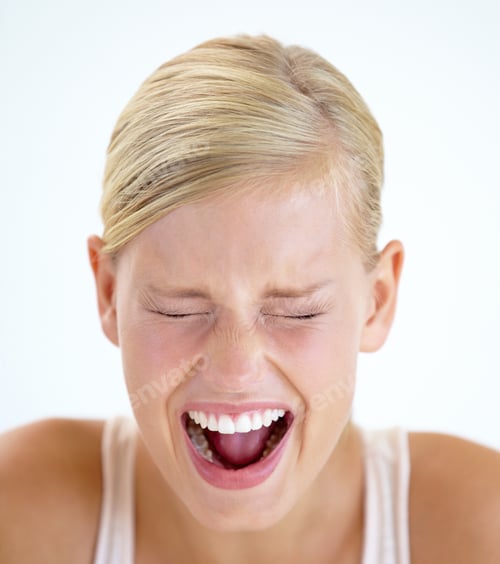 Preview: Venting her emotions. A frightened young woman shrieking with her eyes closed.