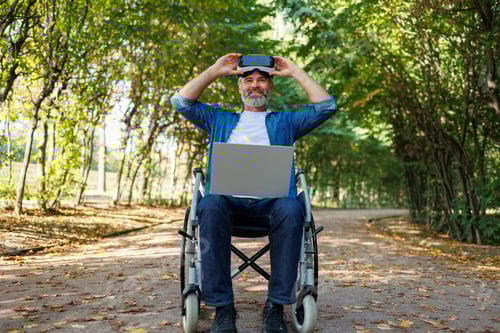 Preview: Man in Wheelchair Using VR Headset in Park