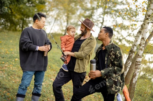 Preview: Multiracial male friends rest in nature at autumn