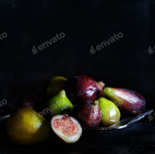 Preview: Green and purple figs on a dark background