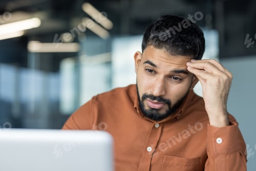 Preview: Stressed businessman thinking problem with hand on forehead