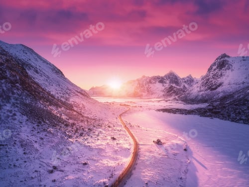 Preview: Aerial view of snowy mountains, road, houses and purple sky