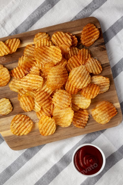 Preview: Barbeque Potato Chips on a wooden board, top view. Flat lay, overhead, from above.