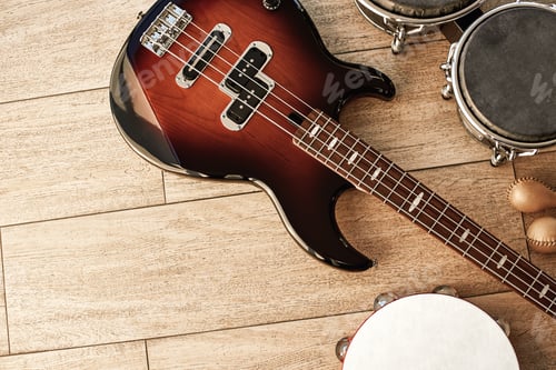 Preview: Ready for performance. Top view of musical instruments set: brown electric guitar, drums, gold