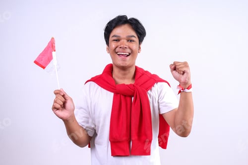 Preview: Man Wear Wrist Band Clenching Fist While Holding Indonesian Flag