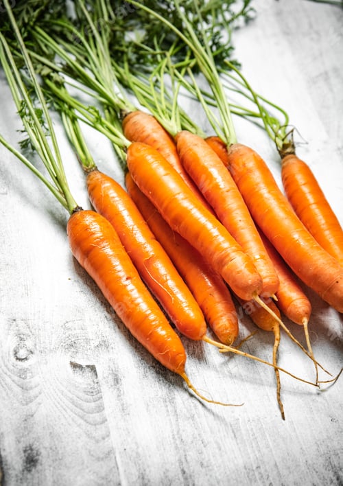 Preview: Fresh carrots on wooden table.