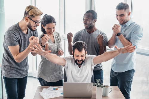 Preview: Business people standing over laptop at table in office