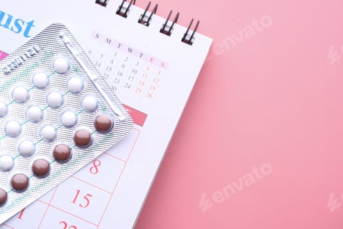 Preview: birth control pills , calendar and notepad on table