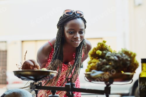 Preview: Shot of a woman peering through a shops window while out on a shopping spree