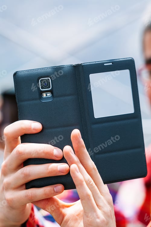 Preview: Person Taking Pictures with a Smartphone with Black Leather Case
