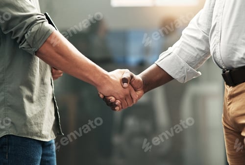 Preview: Cropped shot of a two unrecognizable businessmen standing in the office together and shaking hands
