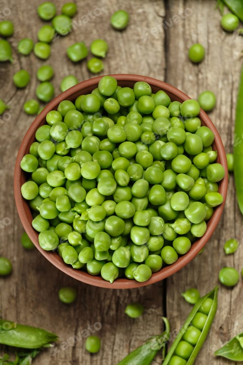 Preview: Green peas in closed and open pods, peeled peas in a bowl, scattered pea seeds on wooden background