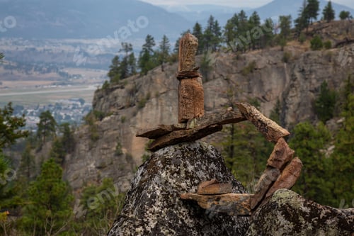 Preview: Stack of balancing rocks in nature during a cloudy summer morning