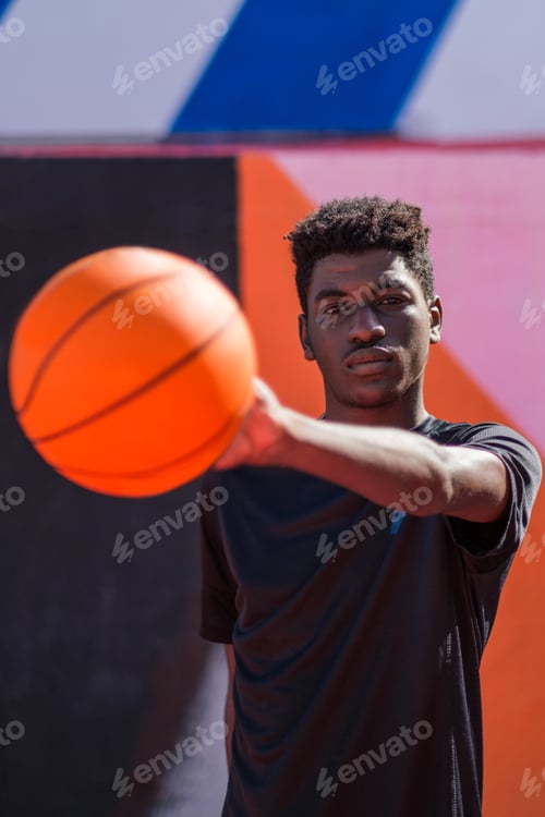 Preview: Young man with afro hair style playing with the basketball