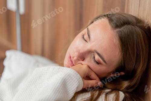 Preview: close up in modern clinic in a bright VIP room lies young girl in a white coat with a cold, medical