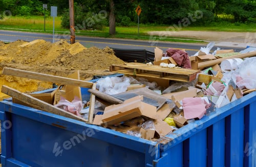 Preview: Industrial garbage bin blue construction debris container filled with rock and concrete rubble.