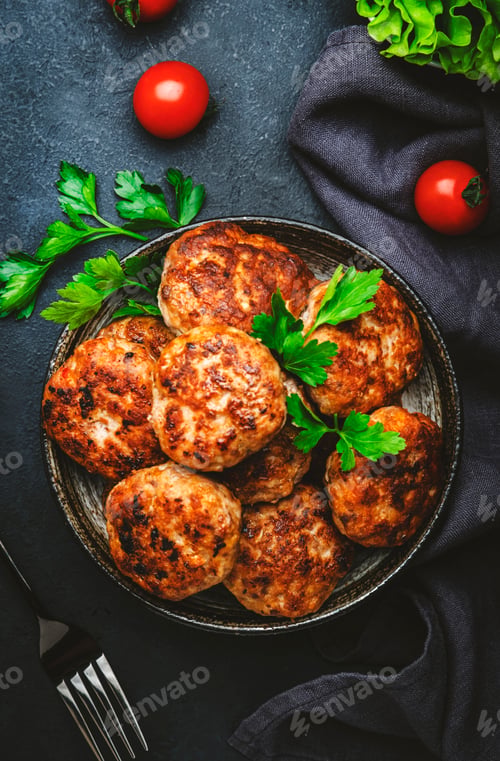 Preview: Homemade fried pork and beef meatballs in bowl, dark table background, top view