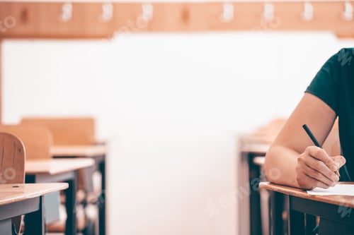 Preview: Student writing final exam in classroom.