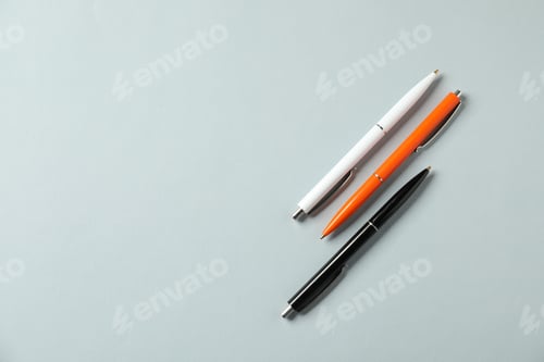 Preview: Stylish pens on grey background, flat lay. Space for text