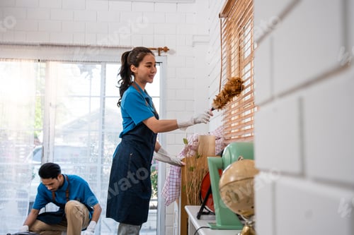Preview: Asian young man and woman cleaning service worker work in living room.