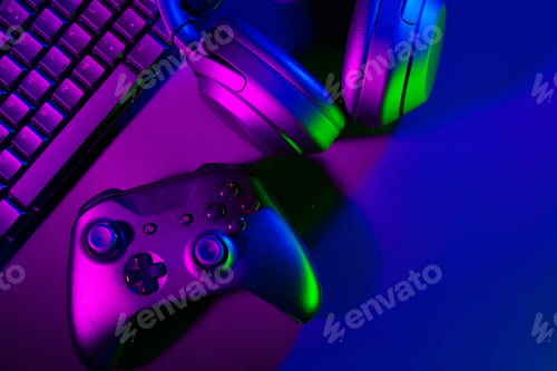Preview: Headphones, joystick and computer keyboard on black table
