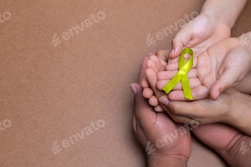 Preview: hands holding green cane ribbon, lymphoma cancer, chocolate background