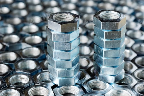 Preview: Close-up of a stack of chrome metal nuts