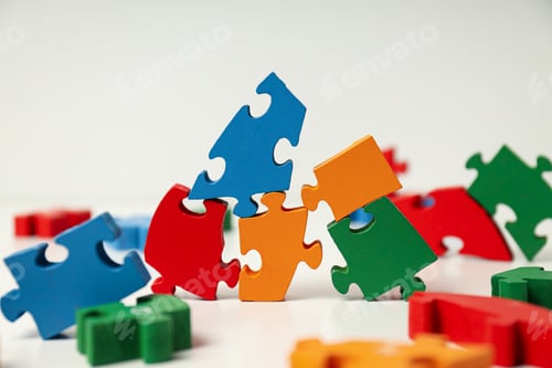 Preview: Multicolored puzzle pieces on a white background. World autism day concept