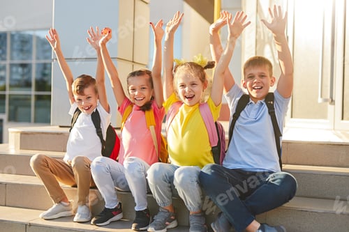 Preview: Happy kids sitting on school steps
