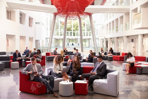 Preview: Businesspeople Using Digital Devices In Busy Office Lobby