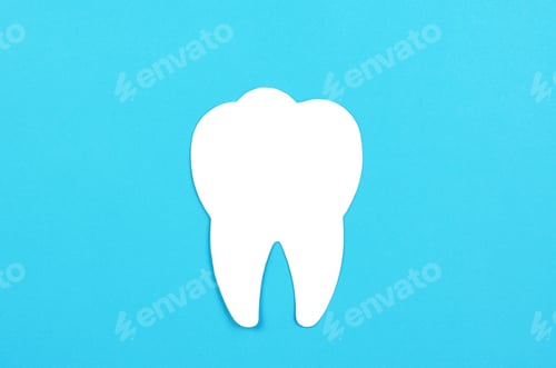 Preview: White tooth on a blue background. Dental care concept, copy space.