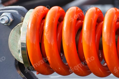 Preview: Hard orange spring made of steel. Part and detail of industrial or agricultural machine