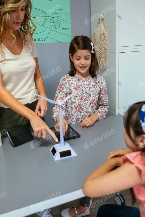Preview: Student showing solar windmill to classmate in ecology classroom