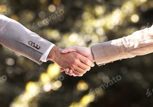 Preview: Lets do this together. Cropped shot of two unrecognisable businesspeople shaking hands in the city.