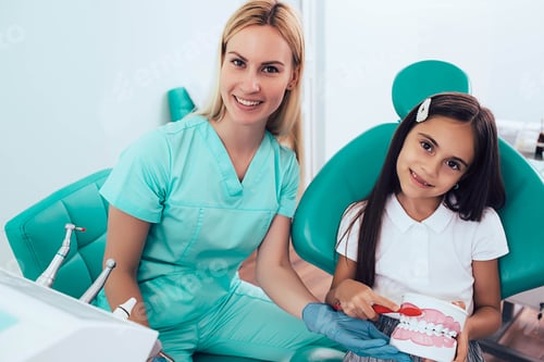 Preview: Pediatric dentist with her little patient at dental clinic