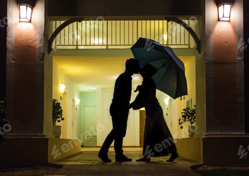Preview: Romantic Couple Silhouette Kissing Under Umbrella At Night
