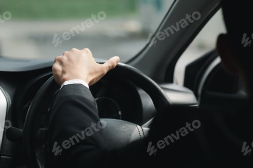 Preview: A man in a suit is driving a car to work, he is driving a car to work at the company. Vehicle drivin