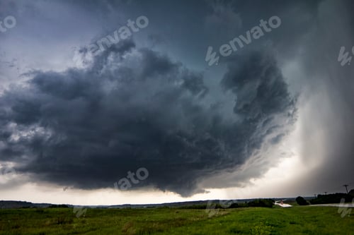 Preview: Ominous storm clouds over a vast field.