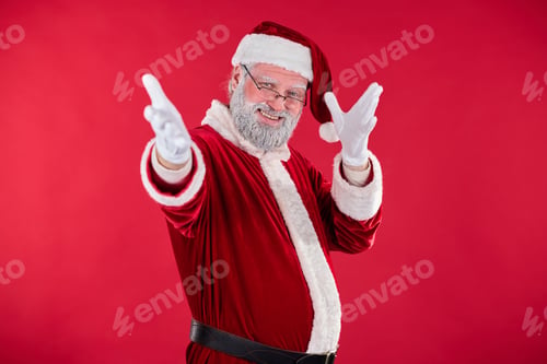 Preview: Smiling Santa Claus Pointing at Camera in Festive Setting