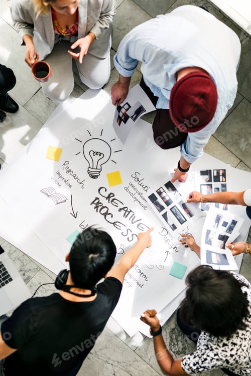 Preview: Business people brainstorming management process on paper