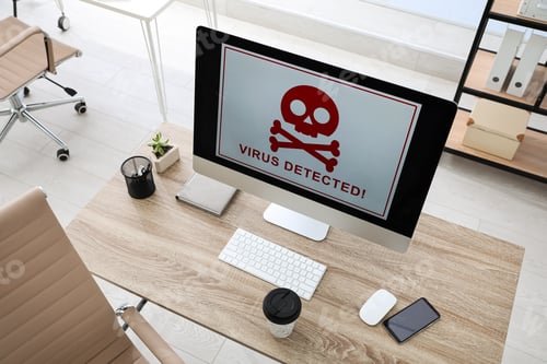 Preview: Computer with warning about virus attack on screen in office